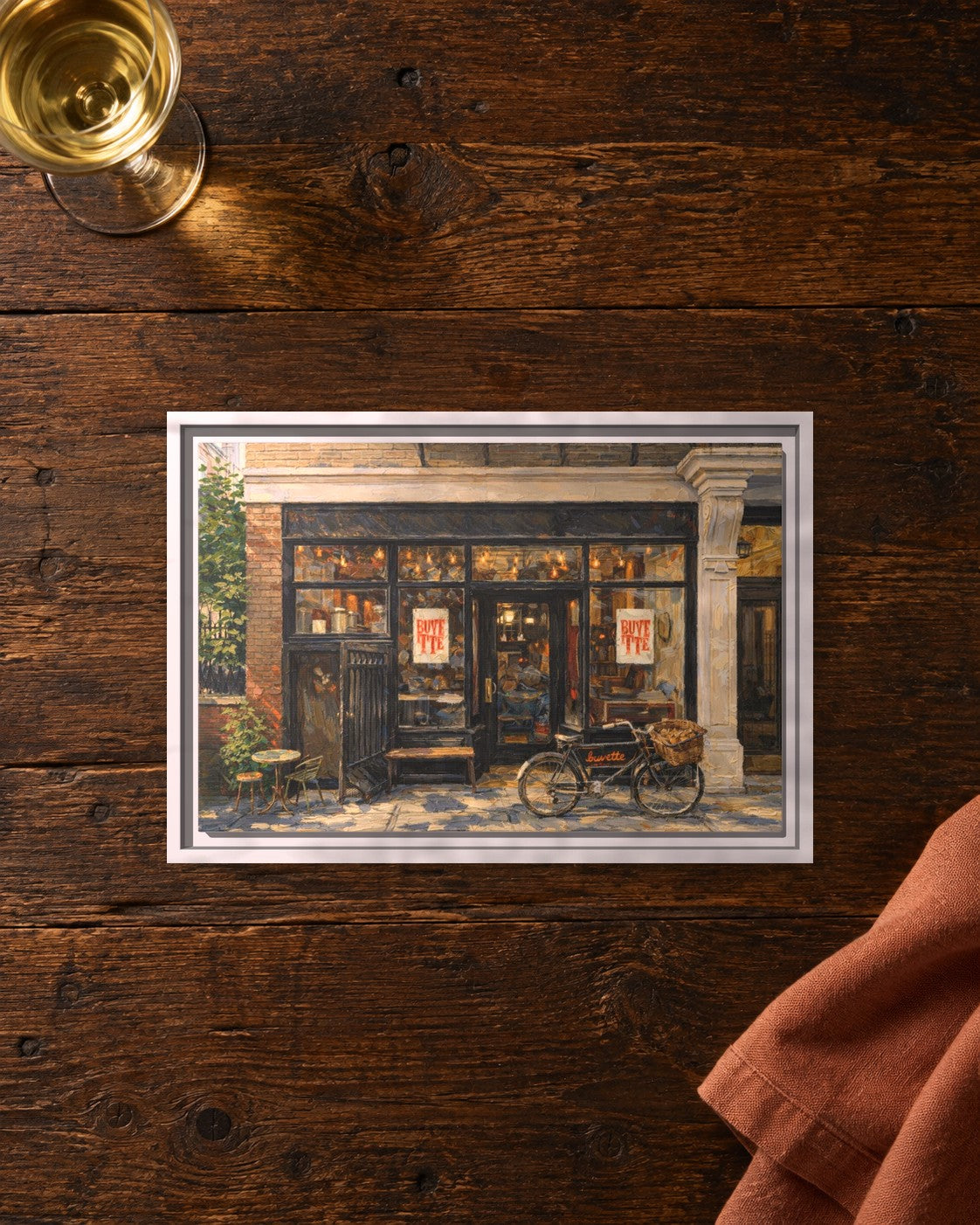 Buvette framed canvas print lying on a table