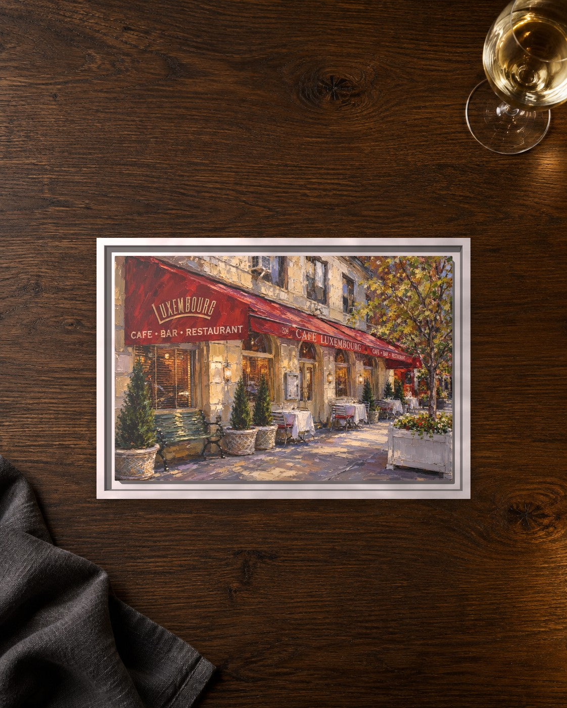 Cafe Luxembourg framed canvas print lying on a table