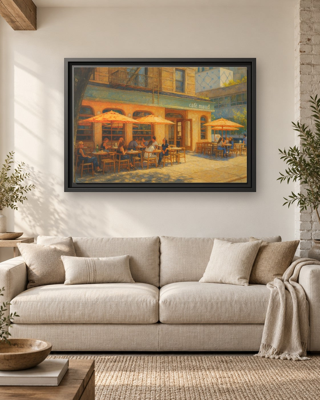 Café Maud framed canvas print hanging above a sofa