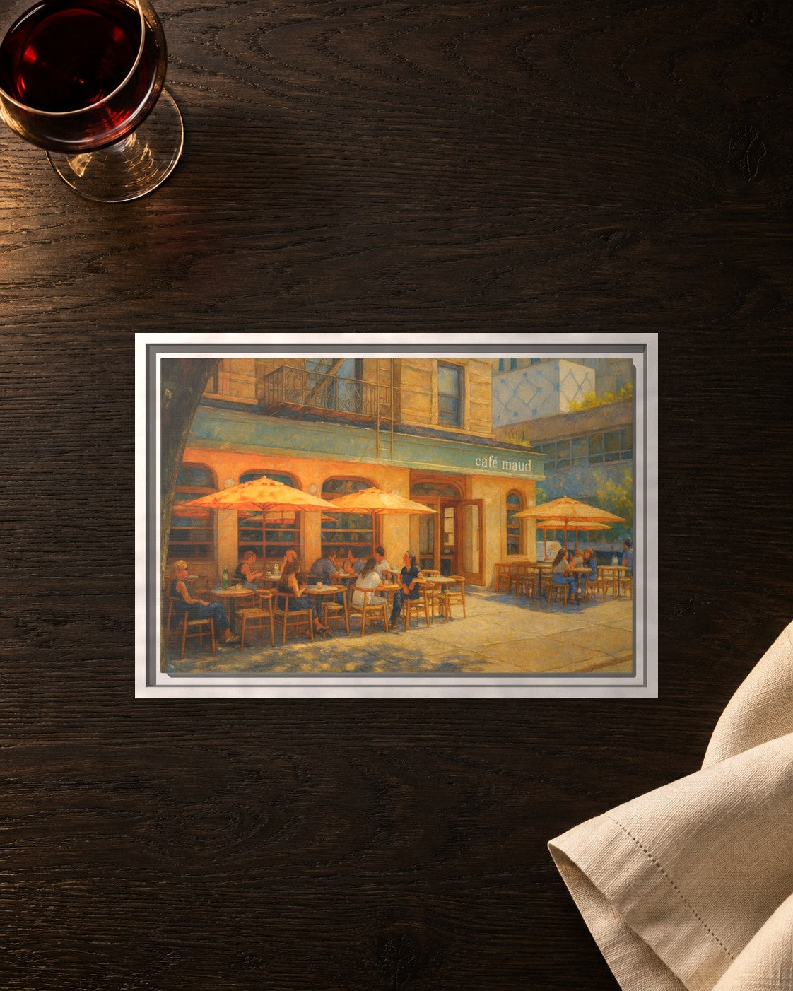 Café Maud framed canvas print lying on a table