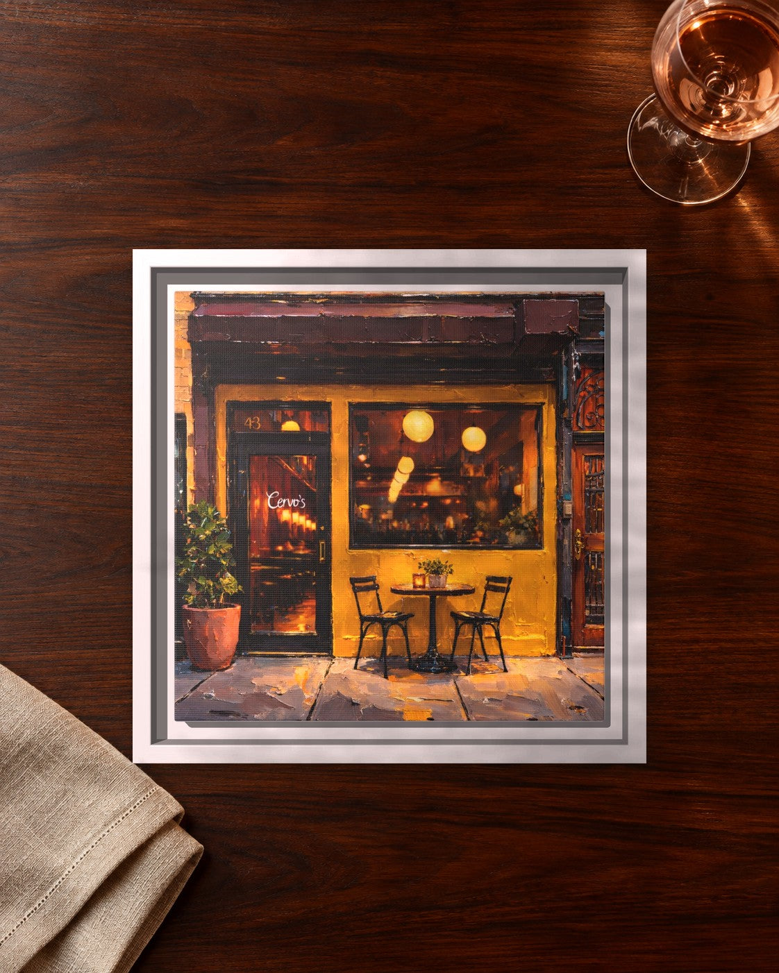 Cervo's framed canvas print lying on a table