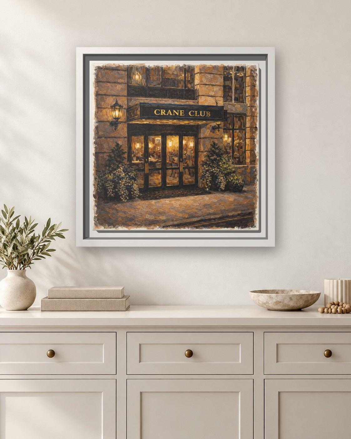 Crane Club framed canvas print hanging above a sideboard