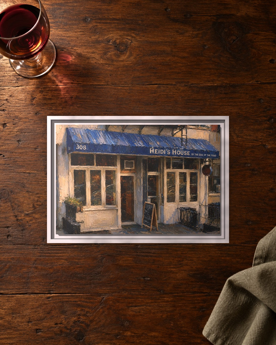 Heidi's House by the Side of the Road & Ed's Elbow Room framed canvas print lying on a table