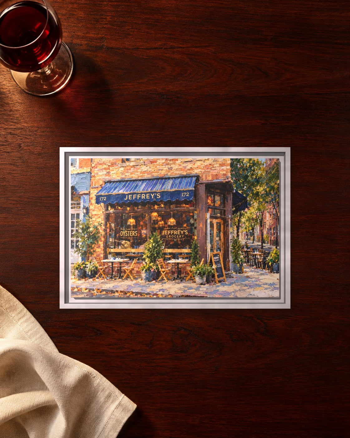 Jeffery's Grocery framed canvas print lying on a table