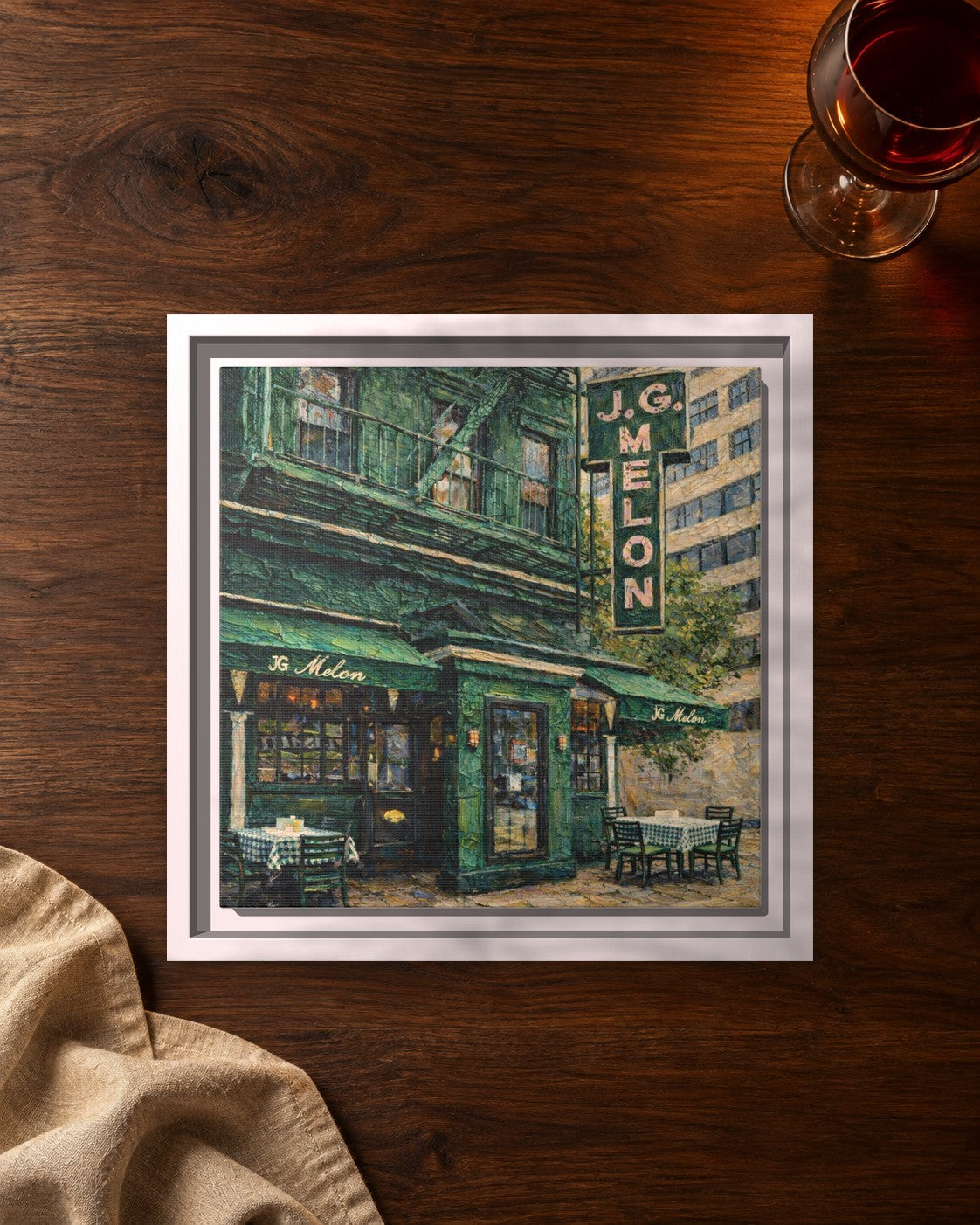 JG Melon framed canvas print lying on a table
