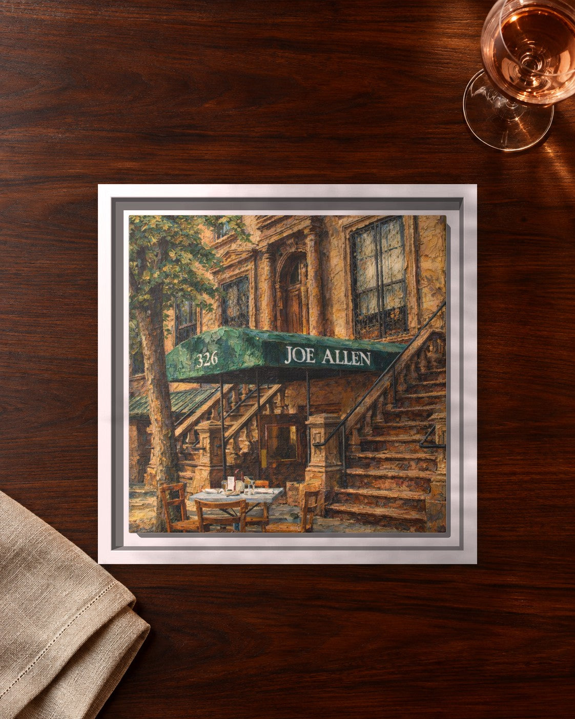 Joe Allen framed canvas print lying on a table