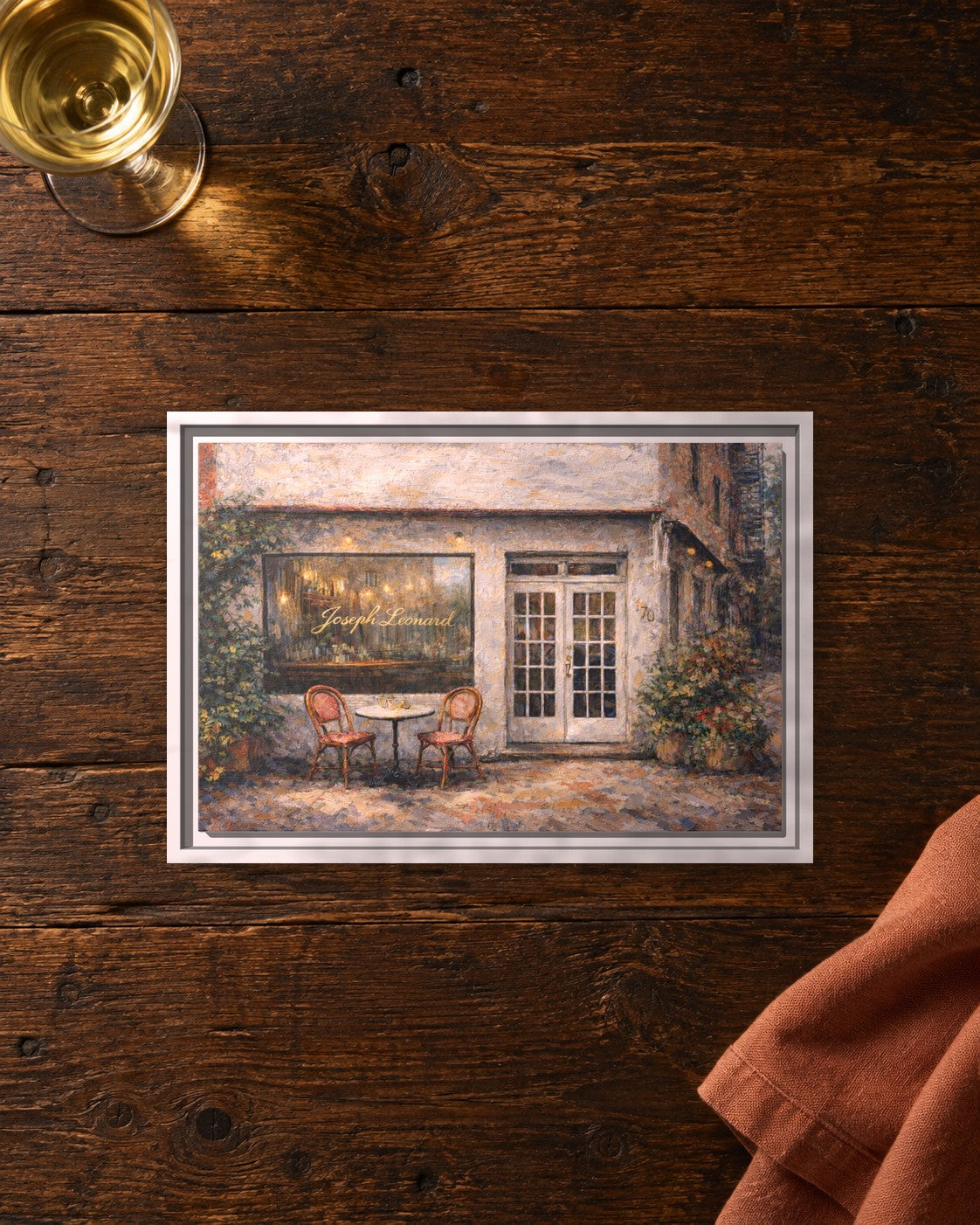 Joseph Leonard framed canvas print lying on a table