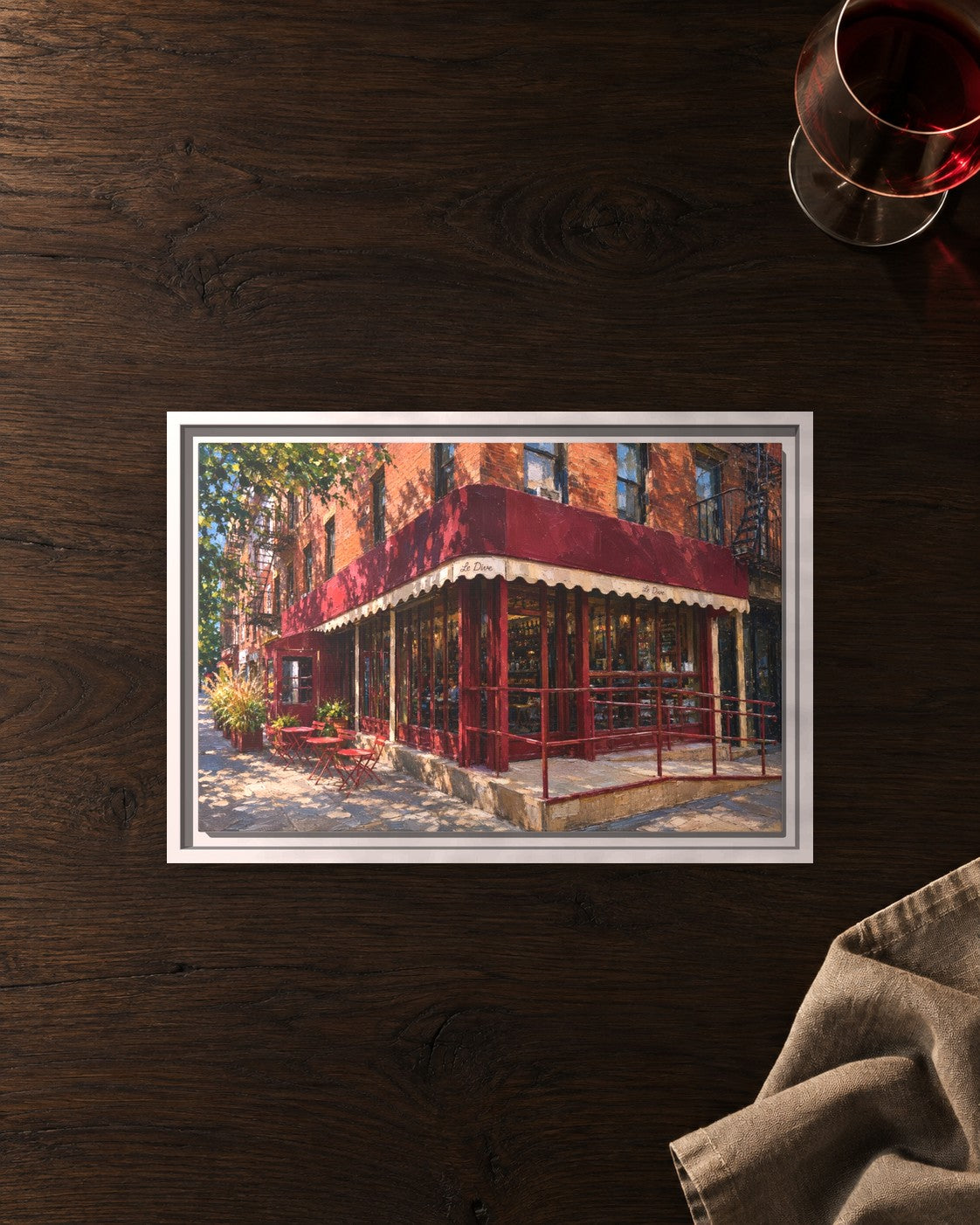 Le Dive framed canvas print lying on a table