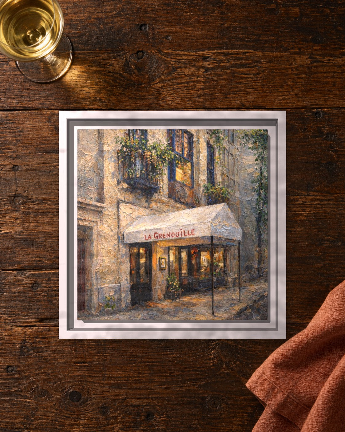 La Grenouille framed canvas print lying on a table