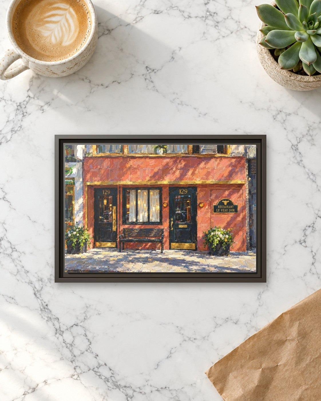 Le Veau d’Or framed canvas print lying on a table