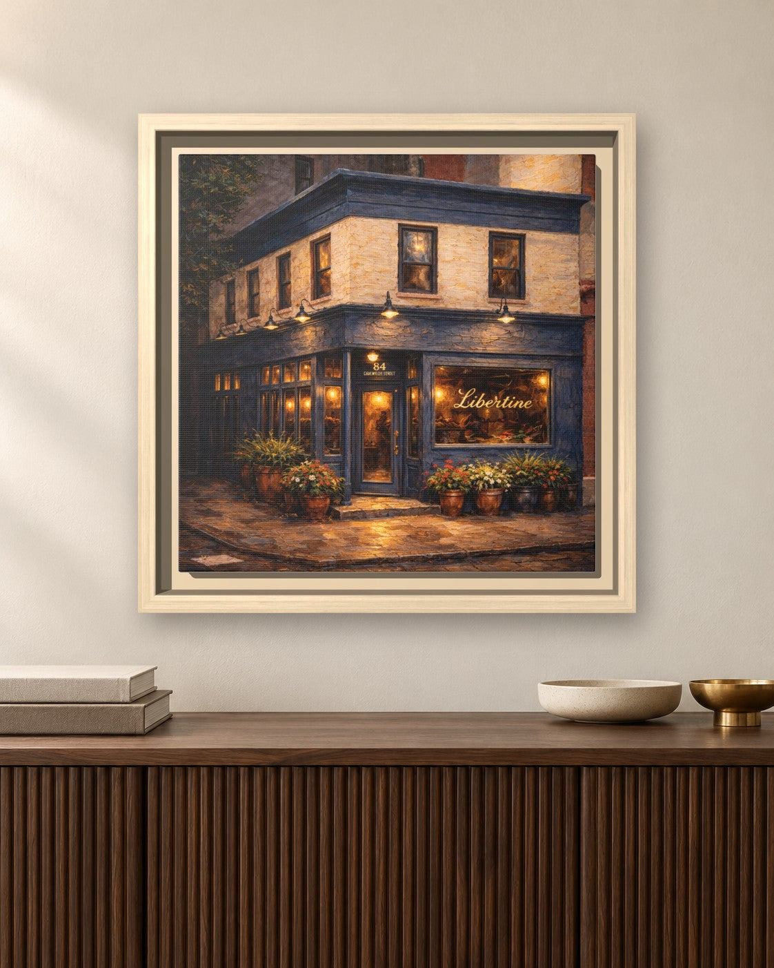 Libertine framed canvas print hanging above a sideboard