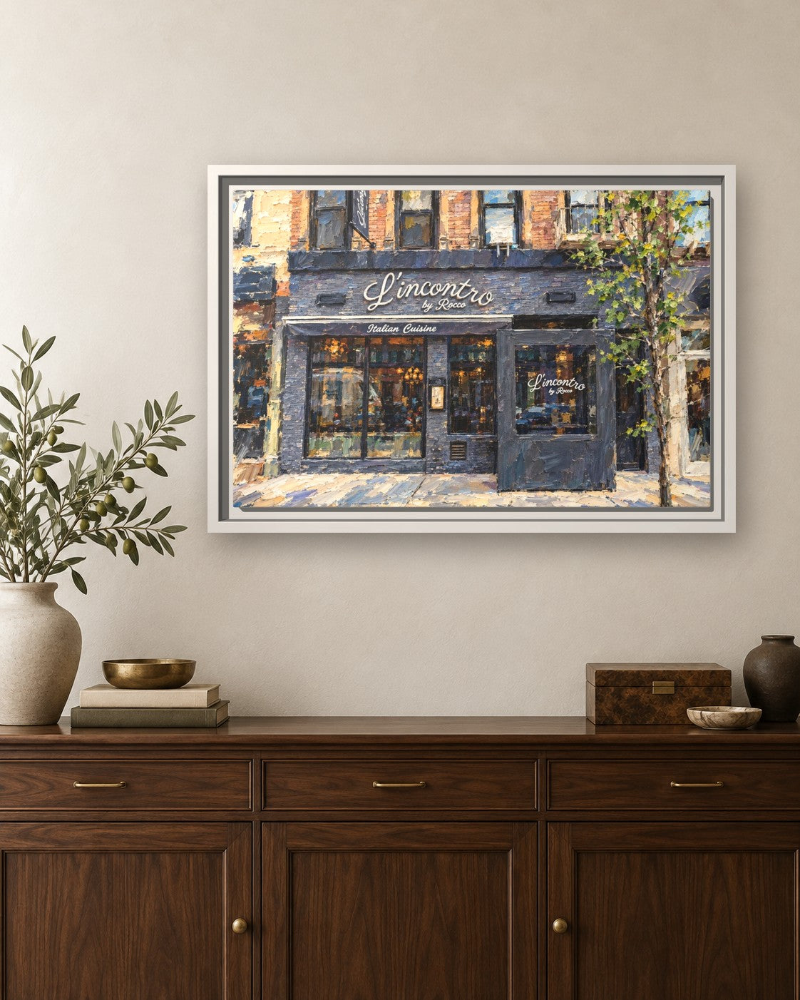 L'incontro by Rocco framed canvas print hanging above a sideboard