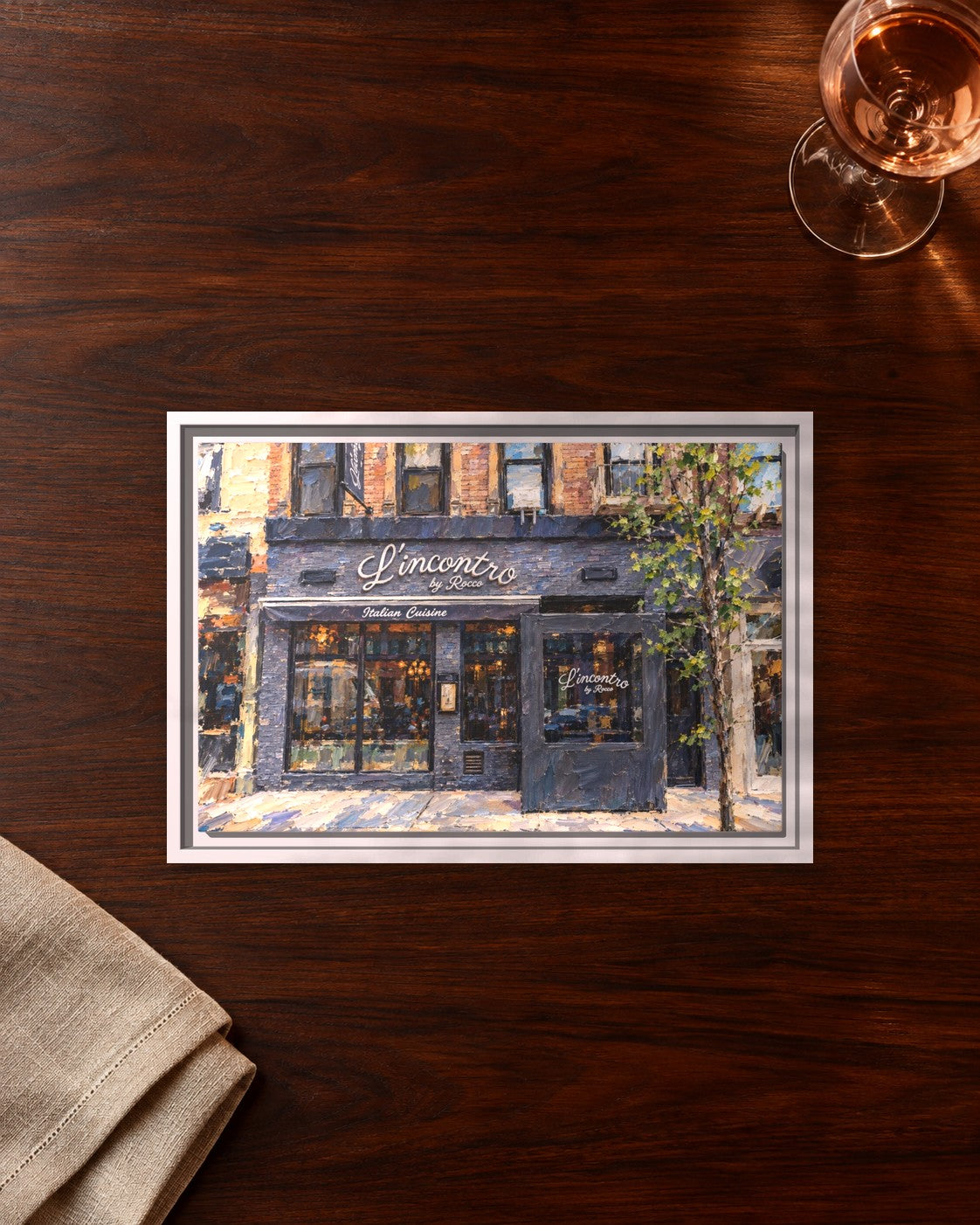 L'incontro by Rocco framed canvas print lying on a table
