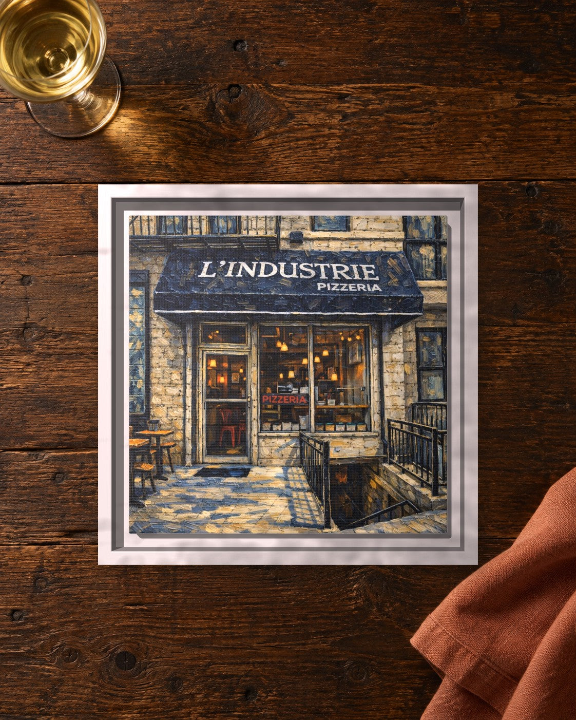 L'industrie Pizza framed canvas print lying on a table