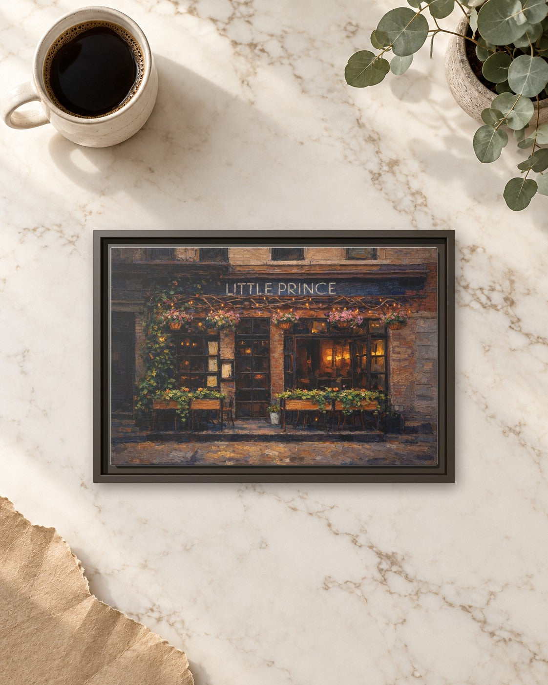 Little Prince framed canvas print lying on a table