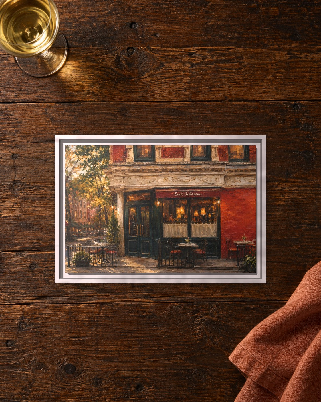 Sant Ambroeus West Village framed canvas print lying on a table