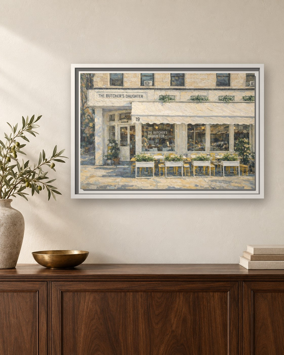 The Butcher's Daughter framed canvas print hanging above a sideboard