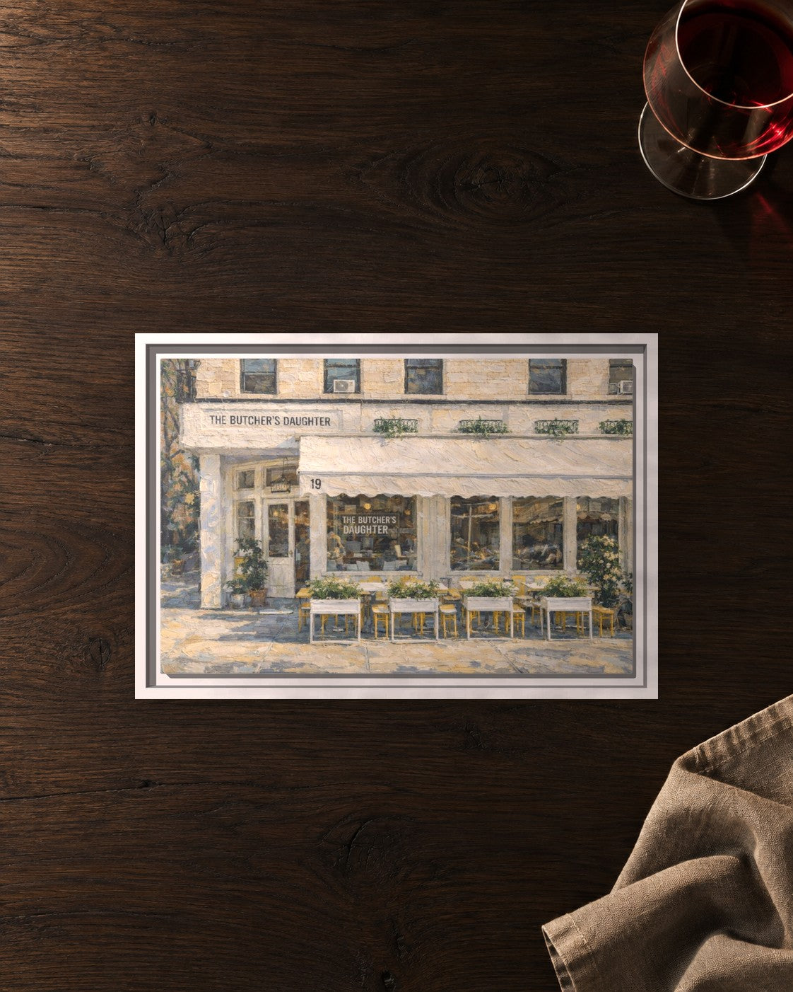 The Butcher's Daughter framed canvas print lying on a table