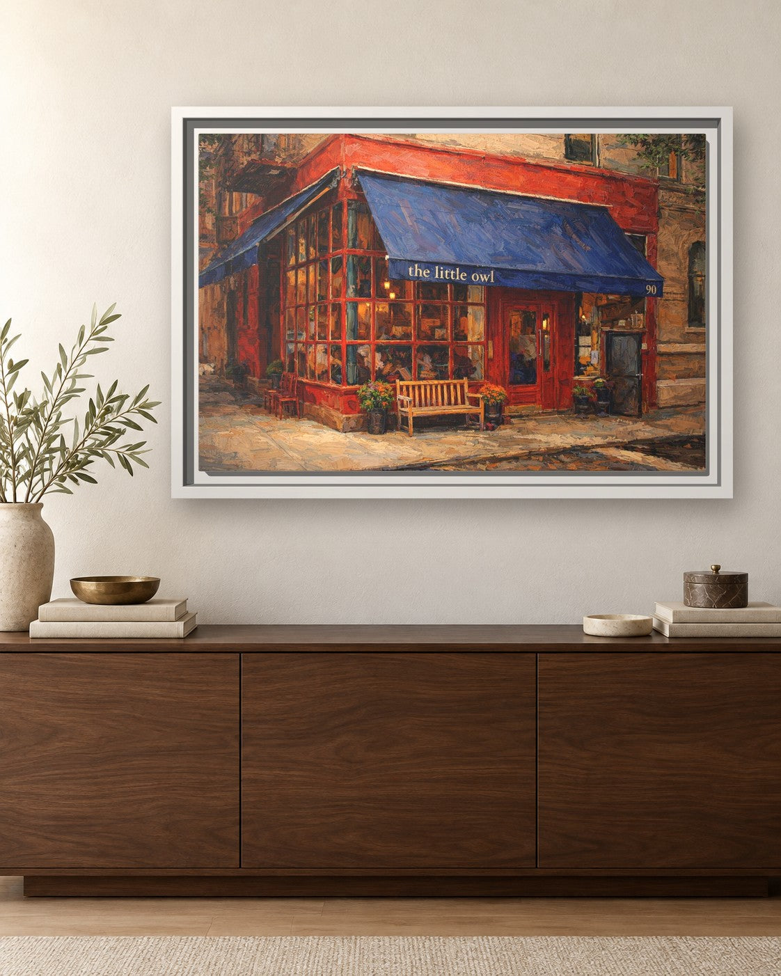 The Little Owl framed canvas print hanging above a sideboard