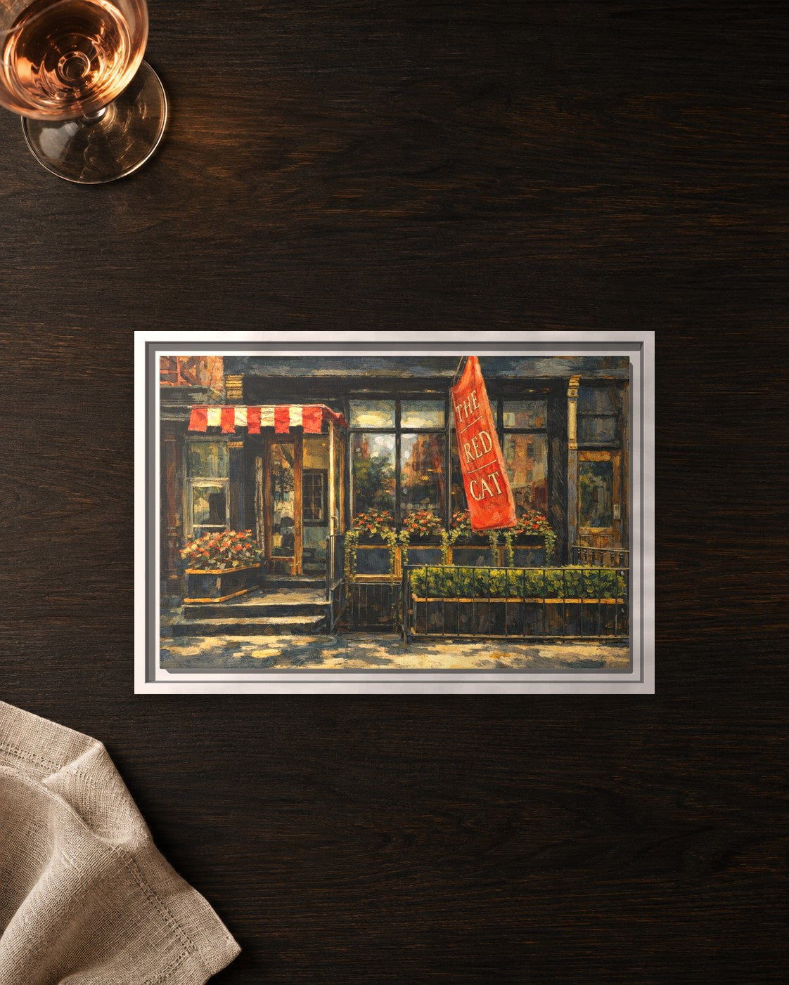 The Red Cat framed canvas print lying on a table